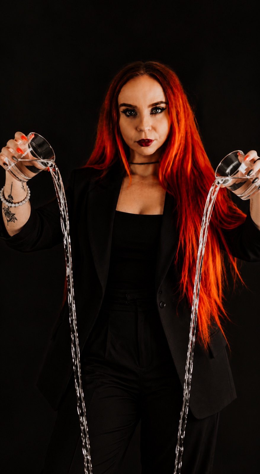 Liz pouring water from two glasses